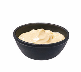 Mayonnaise  in  black bowl isolated on white background