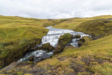 Fototapeta premium River in beautiful icelandic landscape near Skogafoss, Iceland