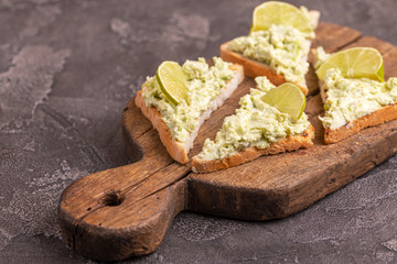 Toasts with avocado pate, fresh microgreen and lime