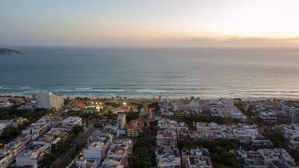 view of city city at dusk with tops and sea in the background