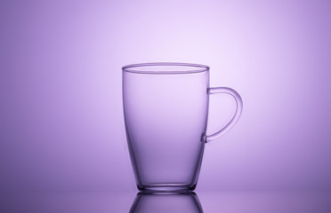 Cup of glass on lilac background.