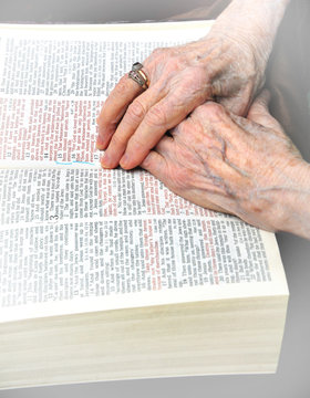 Clasped Hands on Bible