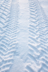 Fototapeta na wymiar Tire tracks in fresh snow