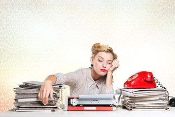 Overworked sleeping woman at workplace on light background