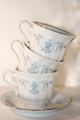 Stack of three vintage porcelain cups. Selective focus.