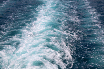 Sea foam oon a water surface. Beautiful blue color. Selective focus.