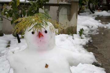Funny snowman in a yard. Selective focus.
