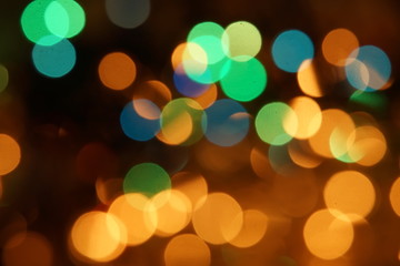 Fototapeta premium natural bokeh holiday lights background bright lights green yellow blue party city