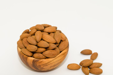 Bowl of almond nuts on white background. Almond nuts isolated. 