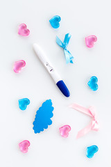 Joy of long-awaited pregnancy. Pregnancy test with clouds and hearts on white background top view
