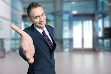 Young happy business man in grey suit