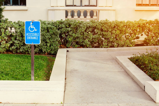 View of a disabled person walk way with a blue handicap sign