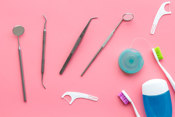 Daily oral hygiene for family. Toothbrush, dental floss and dentist instruments on pink background top view - obrazy, fototapety, plakaty