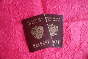Russian passport on a pink background.