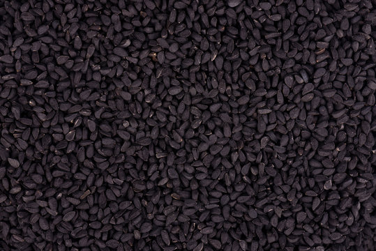 Black cumin seeds. Nigella sativa. Closeup background.