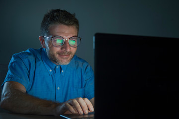 weird tidy and neat nerd man in big glasses and shirt working happy using internet on laptop...