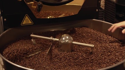 Dark and aromatic coffee beans in modern roasting machine stock footage video