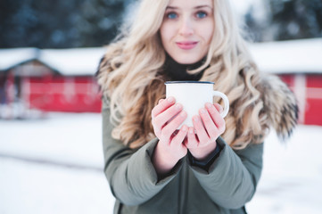 Beautiful smiling woman with mulled wine outdoor.
