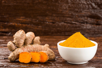 Turmeric powder and fresh turmeric - Curcuma longa.