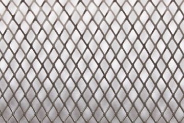 Metal mesh background texture. On white background. Close up. Selective focus.