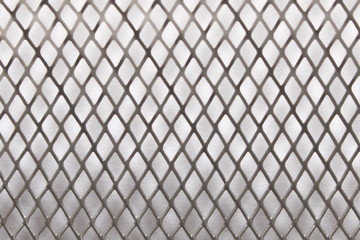 Naklejka premium Metal mesh background texture. On white background. Close up. Selective focus.
