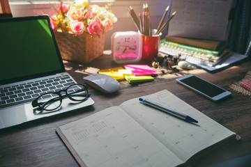 On book or diary,Man's hand planner or organizer writing daily appointment,mark and noted schedule(meeting) on book or diary at office desk.Planner concept