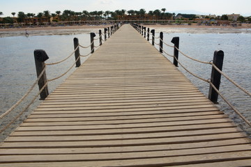 wooden bridge on the sea in a resort area