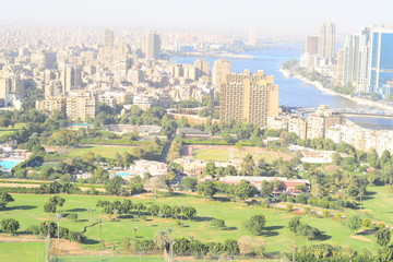 Nile river in Cairo Egypt during the day with boats running and high building surrounding river banks