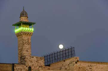 Full moon over Mi'dhanat Bab al-Silsila’s minaret in the Muslim quarter of the Old City of...