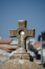 Sun shining through the cross on the rooftop of the St. John the Baptist church in the Old City of Jerusalem, Israel