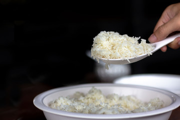 Cooked rice in pot with spoon.