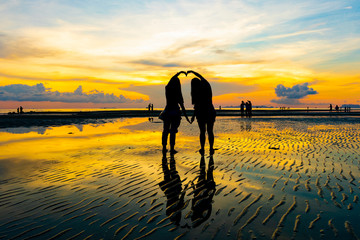 Silhouette of couple lover on the beach