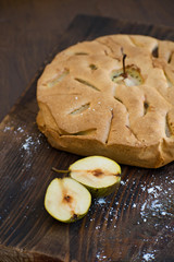 Delicious pear tart on table. Pear tatin pie on wooden board. Homemade organic fresh pear fruit pie or tart backed.