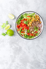 Healthy and delicious bowl with buckwheat and salad of chickpea, fresh pepper and lettuce leaves. Dietary balanced plant-based food. Vegan and vegetarian dish. Top view. Flat lay