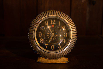old vintage antique clock on wooden background