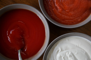 Sauce bowls top view, hot and classic tomato ketchup and sour cream