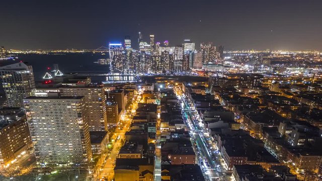 Aerial hyperlapse by night, above Hoboken, New Jersey, between Hudson street and Washington street, with forward motion towards Jersey City skyline