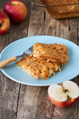 Rice casserole with apples and carrots on a blue plate