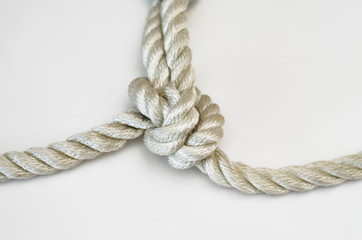 nautical knots tied by the rope of a rope on white background
