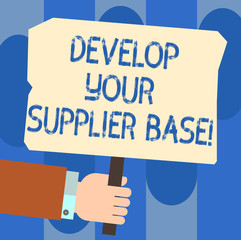 Writing note showing Develop Your Supplier Base. Business photo showcasing Select and establish suppliers relationships Hu analysis Hand Holding Colored Placard with Stick Text Space