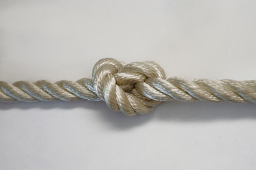 nautical knots tied by the rope of a rope on white background