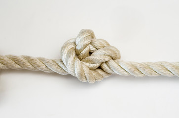 nautical knots tied by the rope of a rope on white background