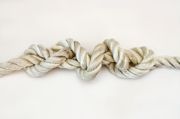 nautical knots tied by the rope of a rope on white background