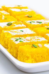 Indian Popular Sweet Food Khopara Pak or Coconut Burfi made up of Coconut, Milk And Sugar Isolated on White Background