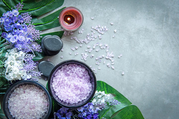 Obraz na płótnie Canvas Lavender aromatherapy Spa with candle and rock spa. Thai Spa relax Treatments and massage concrete background. Healthy Concept. Top view and Copy space for text.