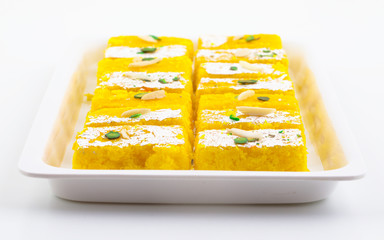 Indian Popular Sweet Food Khopara Pak or Coconut Burfi made up of Coconut, Milk And Sugar Isolated on White Background