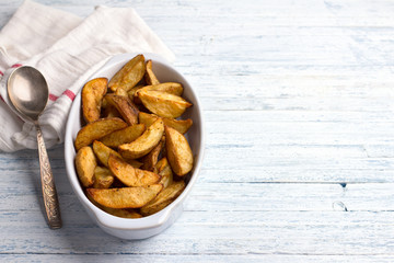 Baked potatoes on a light blue background, selective focus. Delicious vegan homemade food