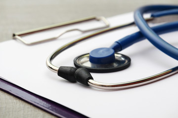A stethoscope and a clipboard for notes as a medical check concept	