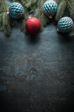 Top of view christmas balls fir tree pine cones on free concrete background
