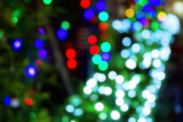 Fototapeta premium White, Red, Blue and Green bokeh light of Festival at night time. Abstract or blurred of light glitter. Glow texture background.